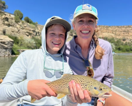 Mother son with brown trout