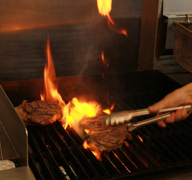 Back cast cafes chef grilling steaks cooking dinner
