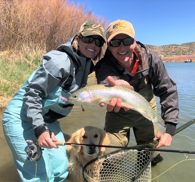 Man and woman holding trout on the san juan river nm
