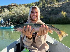 Fly fishing teen wiht rainbow trout san juan river