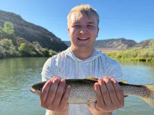 Young bother holding rainbow trout san juan river