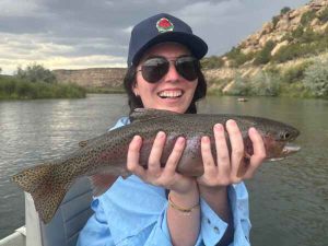 Lady holding rainbow trout san juna river fly fishing